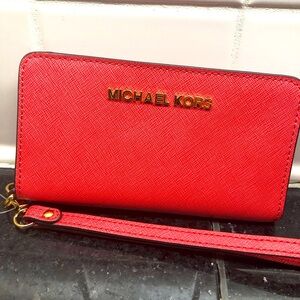 Michael Kors 6 slot wristlet in Beautiful coral 🪸 color, with zipper in back .